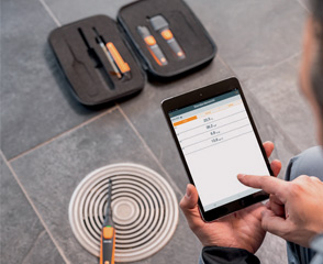 Smart probes kit laying on an air vent while using smartphone
